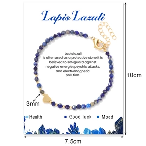 Detail view of 3mm Lapis Lazuli bead bracelet with gold heart charm on display card