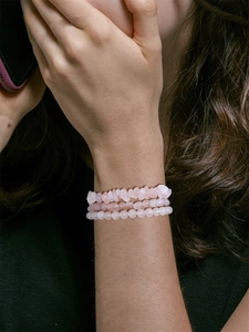 Three-piece set of natural pink crystal bracelets featuring irregular chips and faceted beads