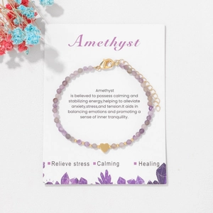 3mm faceted amethyst bead bracelet with 18k gold heart charm on presentation card