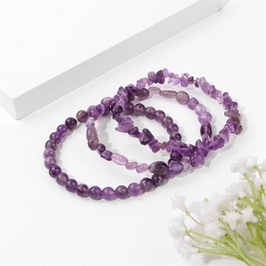 Detailed view of natural amethyst bracelets with round beads and irregular tumbled stones