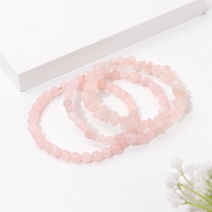 Detail of three-piece natural rose quartz bracelet set featuring beads and raw stones