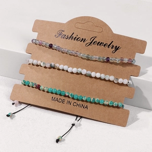 Close-up of three-piece natural stone beaded bracelets set on jewelry display card