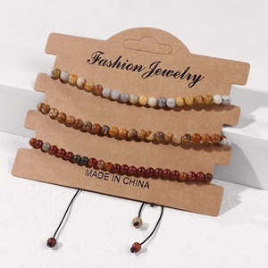 Set of 3 natural stone bead bracelets with adjustable black drawstring on paper card
