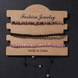 Three-piece beaded bracelet set featuring cat eye stones and braided rope on a display card