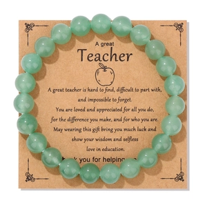 Detail of green beaded bracelet on natural kraft teacher gift card with inspirational quote