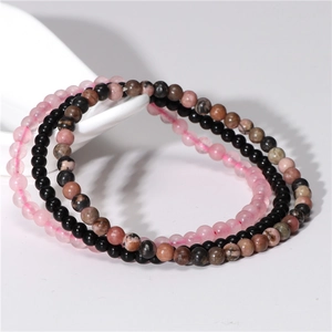 Detailed view of 4mm natural amethyst and agate stretch bracelets on white decor