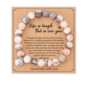 8mm pink zebra stone stretch bracelet with silver heart charm on kraft display card