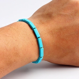 Close-up of rectangular sky blue turquoise bead bracelet worn on a person's wrist