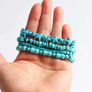 Set of four turquoise beaded bracelets featuring starfish and geometric stone charms