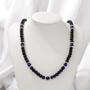 Elegant beaded necklace featuring black agate and blue yoga beads on a white mannequin stand