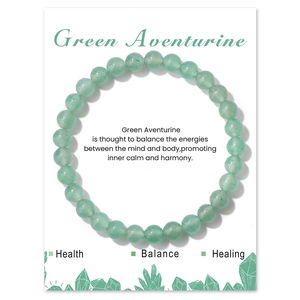 Detail view of 6mm Green Aventurine crystal bead bracelet on a decorative gift card