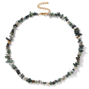 Macro detail of Bohemian irregular natural crystal stone necklace with golden lobster clasp