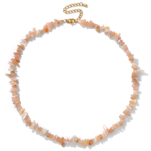 Detailed macro view of irregular natural crystal stone necklace with gold lobster clasp