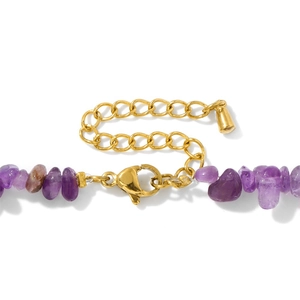 Macro detail of natural irregular purple amethyst stones with gold lobster clasp and chain