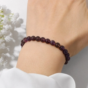 Elegant 6mm natural purple crystal beaded bracelet worn on a wrist for minimalist style