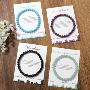 Natural 8mm crystal stone elastic bracelets with amethyst and obsidian on wooden background