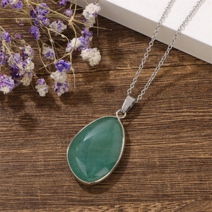 Detail of water drop green aventurine pendant with silver edging on stainless steel chain