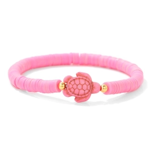 Detailed shot of pink heishi clay beads and turtle charm with golden accents
