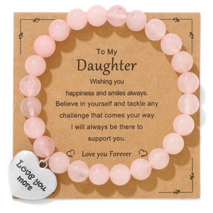Detailed macro view of pink zebra bead bracelet with heart charm on gift card