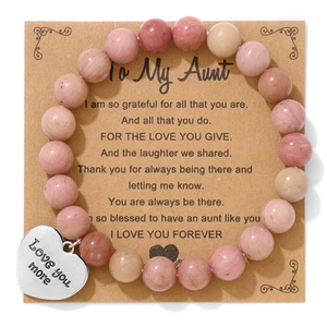 Detail of pink stone beaded bracelet with Love You More heart pendant and aunt gift card