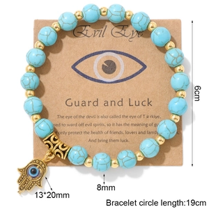 Bracelet Main de Fatma avec perles en turquoise bleue de 8mm et pendentif Mauvais Œil