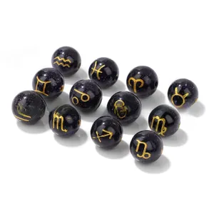 Macro detail of 10mm blue goldstone beads with golden twelve zodiac constellation symbols
