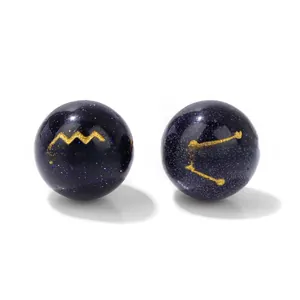 Macro shot of 10mm blue goldstone beads featuring golden zodiac symbols for DIY jewelry