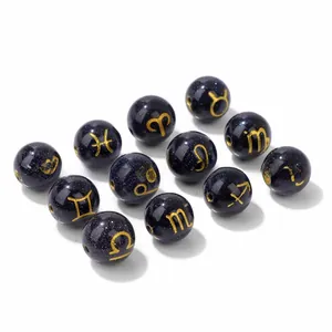 Detailed macro view of 10mm blue goldstone beads with engraved golden zodiac signs