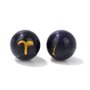 Detail view of 10mm blue goldstone beads featuring golden Aries constellation symbols