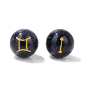 Macro shot of 10mm blue sandstone beads featuring golden Gemini zodiac sign and starry texture
