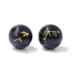 Detailed view of 10mm blue sandstone beads with gold Sagittarius and Libra zodiac symbols