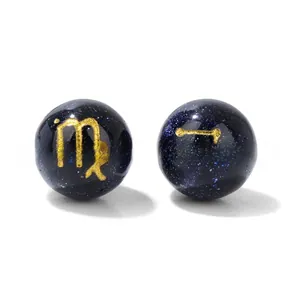 Detailed macro view of 10mm blue sand beads with golden zodiac patterns for DIY jewelry