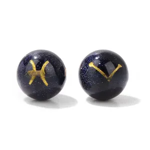 Detailed macro view of 10mm blue goldstone beads featuring golden Pisces zodiac signs