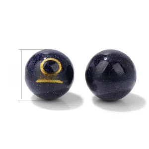 Close-up of 10mm blue goldstone beads with Libra and Sagittarius zodiac gold symbols
