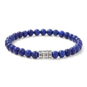 Macro view of 6mm Lapis Lazuli beads with an engraved silver Buddhist mantra cylinder