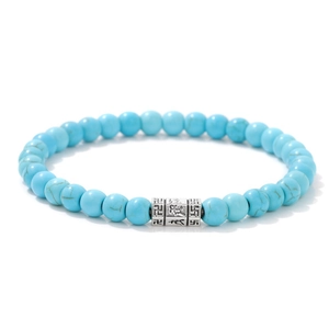 Detail of 6mm turquoise stone beads with silver charms and religious engravings