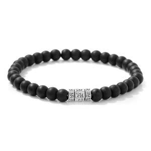 Detail of 6mm matte black stone beads bracelet with engraved silver mantra cylinders