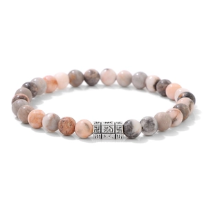 Detail of 6mm natural stone beaded bracelet with engraved silver mantra metal bead