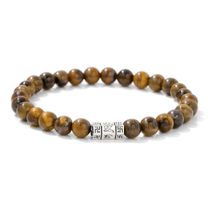 Macro detail of 6mm tiger eye stone beads bracelet with engraved silver mantra charm