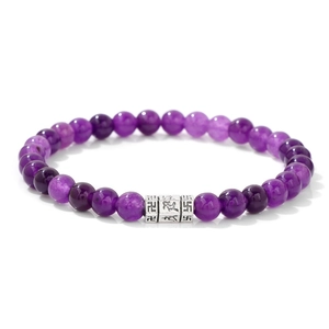 Close-up of 6mm purple natural stone beads with engraved silver mantra charm spacers