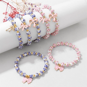 Handmade porcelain flower beaded bracelet with pink enamel bow charm for women