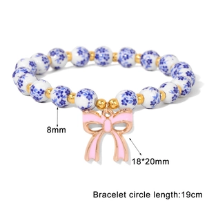 Blue floral porcelain bead bracelet with 8mm beads and a pink bow charm for women