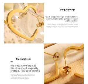 Close-up detail of heart pearl earrings in 18K gold plated titanium steel finish