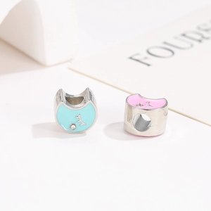 Macro detail of cat-shaped enamel charms with rhinestones for DIY bracelet making