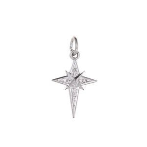 Macro shot of silver eight-pointed star pendant with sparkling cubic zirconia crystals