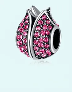 Macro detail of tulip flower bead charm with pink zirconia crystals in silver metal