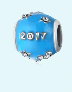Detailed view of blue enamel round bead featuring silver 2017 engraving and star crystals