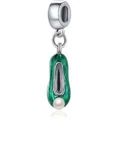 Detail view of green enamel ballet shoe pendant with white faux pearl and silver hook