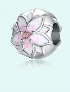 Detailed view of cherry blossom charm with pink enamel petals and drop zircon inlay