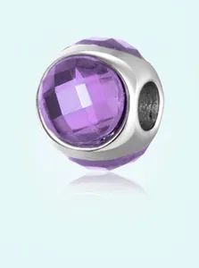 Macro detail of a purple faceted crystal charm with silver hollow bead for DIY bracelets